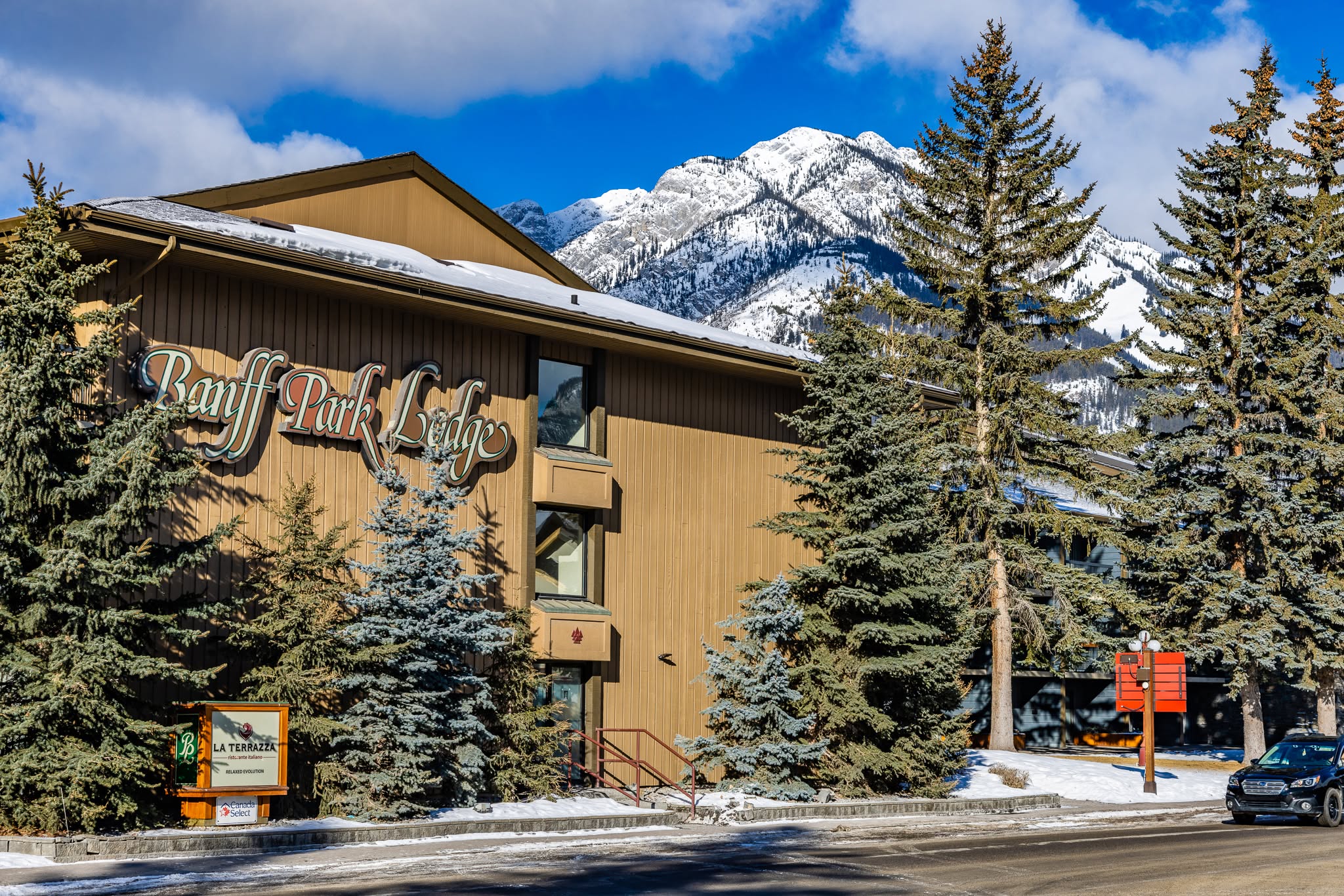 Banff Park Lodge in winter with snow-capped Rockies